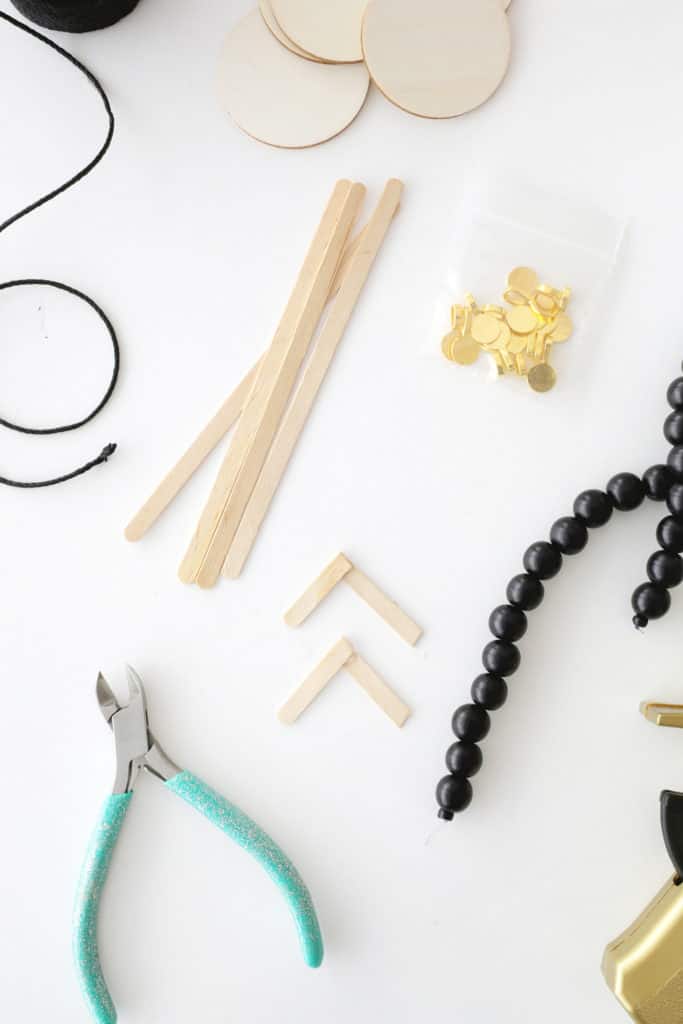 wooden popsicle stick quarters glued together to make legs